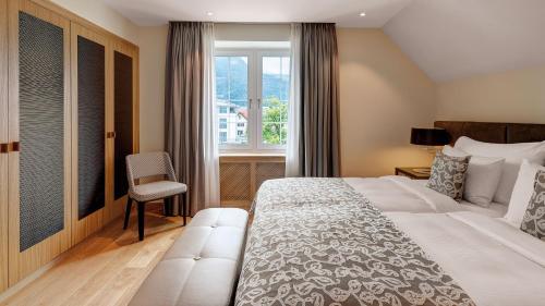 a hotel room with a bed and a window at Residenz Alte Post Bonaduz in Bonaduz