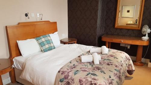 a hotel room with a bed with towels on it at The Antelope at Upavon in Upavon