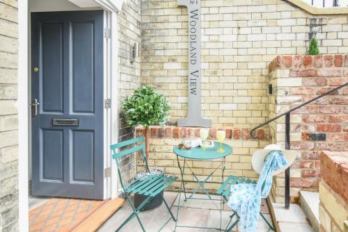 a patio with a blue door and chairs and a table at Woodland View in York