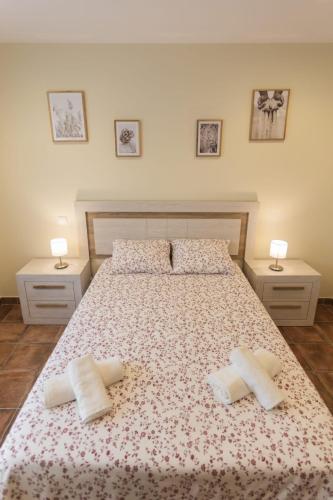 a bedroom with a bed with two pillows on it at Apartamentos el Proel in Pedreña