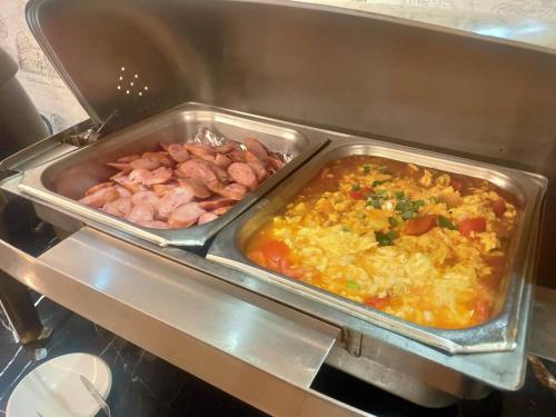 two trays of food in a restaurant kitchen at Discovery Motel - Nangang臺北市旅館349-2號 in Taipei