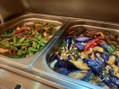 two metal containers filled with different types of food at Discovery Motel - Nangang臺北市旅館349-2號 in Taipei
