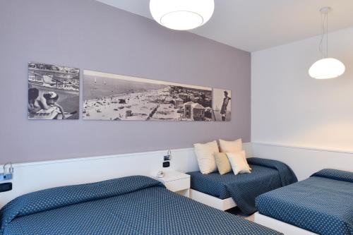 Ένα ή περισσότερα κρεβάτια σε δωμάτιο στο Hotel & Residence Progresso