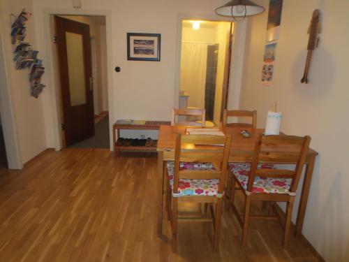a dining room with a wooden table and chairs at Teigur Guesthouse in Akranes