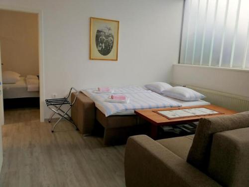 a room with a bed and a table and a couch at Apartma AS in Lesce