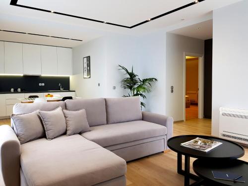a living room with a couch and a table at ArtNest Luxury Hotel & Suites in Sarandë