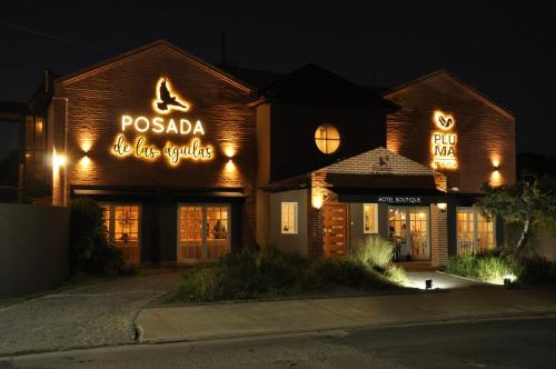 a restaurant with neon signs on the side of a building at Posada de las Aguilas Hotel Boutique in Ezeiza