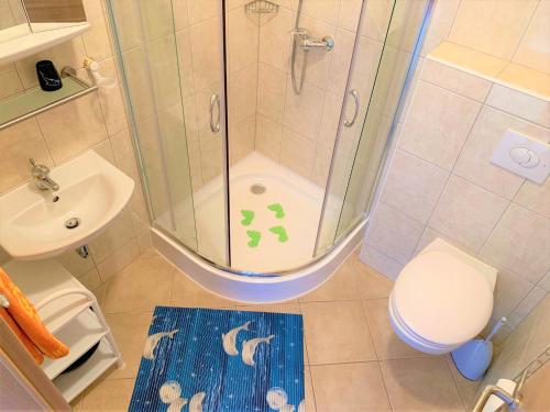a bathroom with a shower and a toilet and a sink at Pranjic Delux Guest House in Vodice