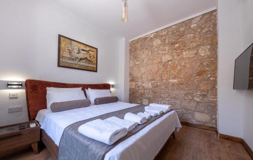 a bedroom with a large bed with towels on it at La Regina Veneziana in Mağusa
