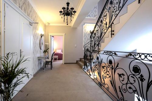 a hallway with a black wrought iron railing at Hotel Madelaine in Lwówek Śląski