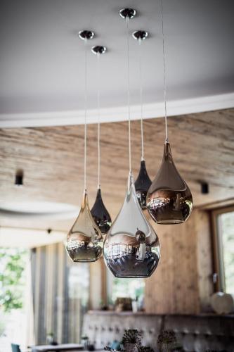 a group of lights hanging from a ceiling at Verwöhn-Wellnesshotel Walserhof in Hirschegg