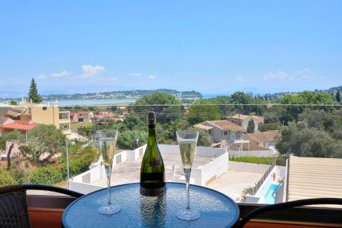 a bottle of wine sitting on a table with two glasses at Alex Apartment Suites in Virós