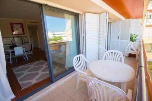 a balcony with a white table and chairs on it at Vacations home Albufeira in Albufeira