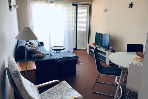 a living room with a couch and a table at Vacations home Albufeira in Albufeira