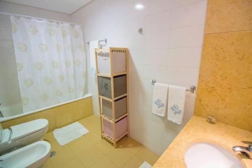 a bathroom with a sink and a toilet at Vacations home Albufeira in Albufeira