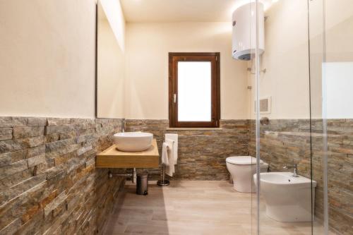a bathroom with a sink and a toilet at Aria di Mare Apartments in Trapani