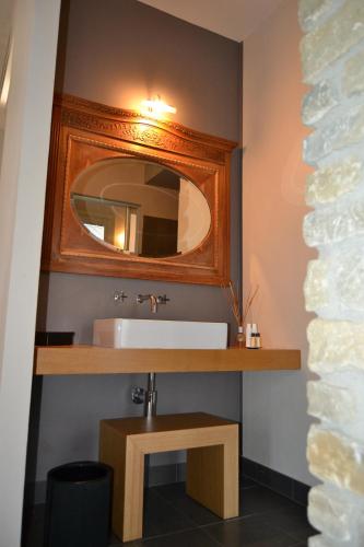 a bathroom with a sink and a mirror at Relais Borgo del Gallo in Acqui Terme