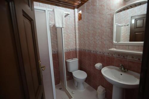a bathroom with a toilet and a sink at Paradise Hotel in Kemer