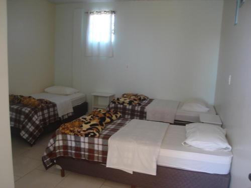 Ένα ή περισσότερα κρεβάτια σε δωμάτιο στο Hotel Alvorada