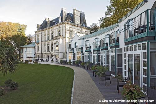 a large building with a lawn in front of it at Clos de Vallombreuse, The Originals Relais in Douarnenez