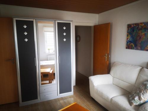 a living room with a couch and a room with a window at Ferienwohnungen und Ferienhaus im Nixenweg in Hohwacht