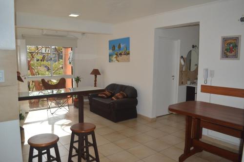 a living room with a couch and a table and chairs at Departamentos Rodrigo in Posadas