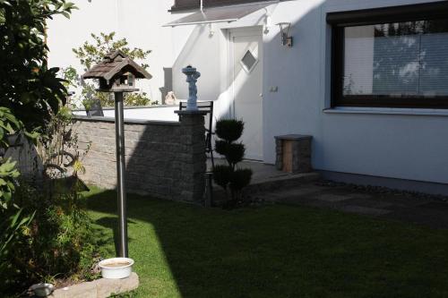 a bird feeder in the yard of a house at Maisonette Deluxe by fewo-amperland in Olching