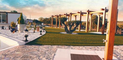 a park with a pavilion with trees and grass at Olívale - Turismo Rural in Campo Maior