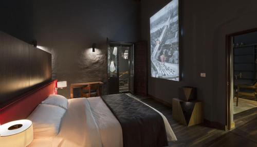 a bedroom with a large bed and a large screen at Casa Restauro in Puebla