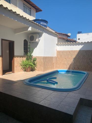 a swimming pool in the middle of a patio at Zaca’s House in Vila Velha