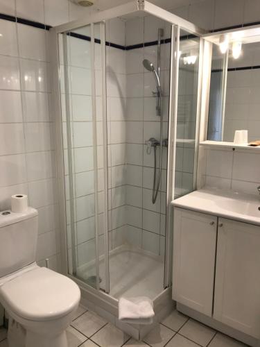 a bathroom with a shower and a toilet at Lyo Hôtel - Centre Lyon Perrache in Lyon