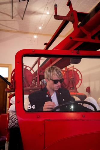 a man is sitting in a red vehicle at Fire Station Inn in Adelaide