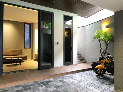 a scooter parked on a porch of a house at Khe Suites Le Lai Apartment - Self Check-in with Lockbox in Da Nang