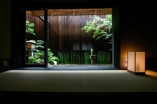 a room with a window with a view of a garden at Rinn Premium Hiun in Kyoto