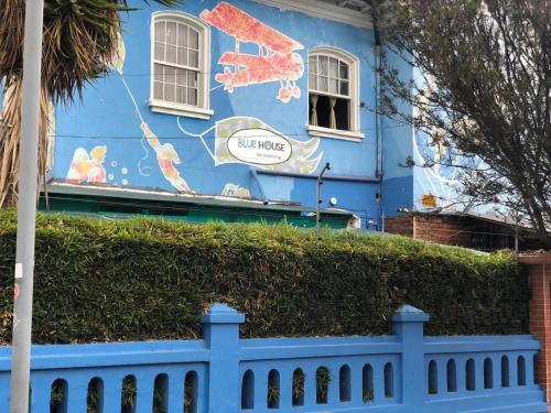 a blue building with a mural of crabs on it at Blue House Youth Hostel in Quito