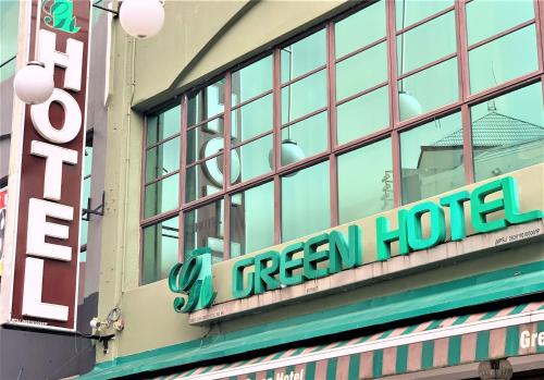 a hotel sign on the side of a building at Green Hotel in Puchong