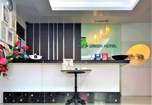 a kitchen with a counter with a table in it at Green Hotel in Puchong
