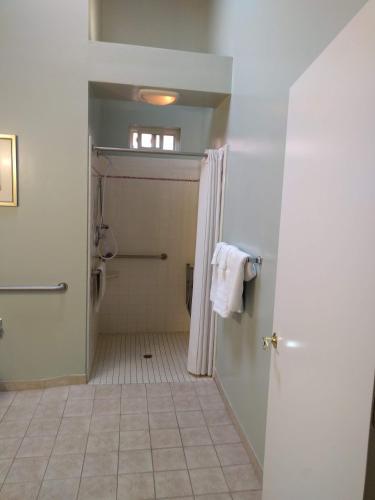 a bathroom with a shower and a toilet at Butterfly Grove Inn in Pacific Grove