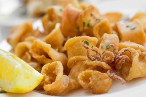 a pile of pasta with a lemon on a plate at Hotel Colombo in Breda di Piave