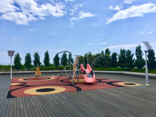 a park with a playground with a pink swing at Homesuite' Home at Sutera Avenue in Kota Kinabalu