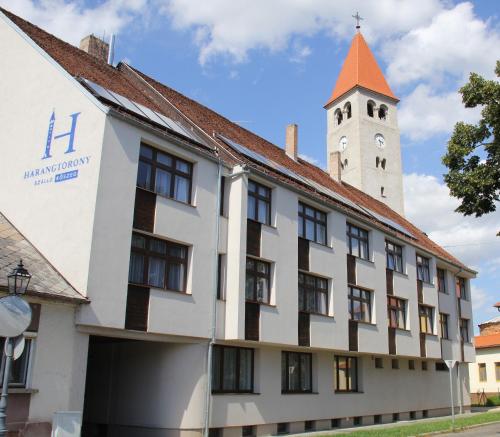 a building with a clock tower in the background at Harangtorony Szálló in Kőszeg