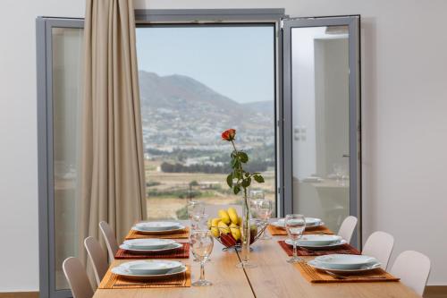 a dining room table with a view of a mountain at Villa Jessy 150m² with Full Privacy in Parikia