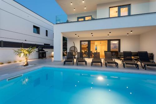 a swimming pool in a house with a house at Villa Manhattan in Dobrinj