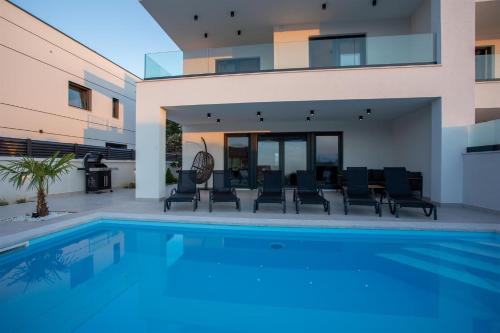 a swimming pool in the backyard of a house at Villa Manhattan in Dobrinj