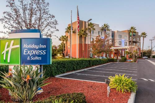 a sign in a parking lot in front of a hotel at Holiday Inn Express Fremont - Milpitas Central by IHG in Fremont