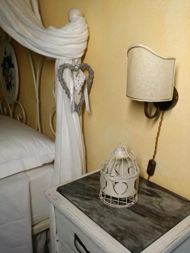 a bedroom with a bed with a dress and a lamp at Agriturismo Il Casalino in Pienza