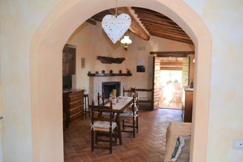 a dining room with a table and a fireplace at Agriturismo Il Casalino in Pienza