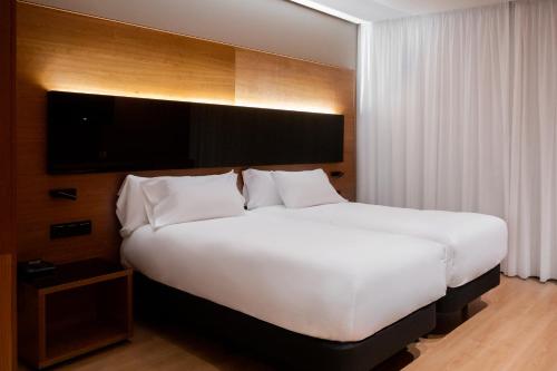 En eller flere senge i et værelse på Hq La Galeria