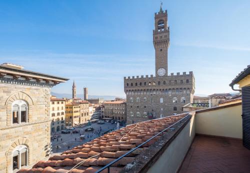 a large clock tower towering over a city at Relais Piazza Signoria in Florence