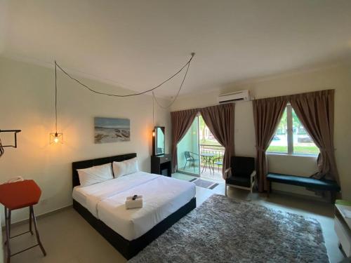 A bed or beds in a room at Tiara Desaru Resort